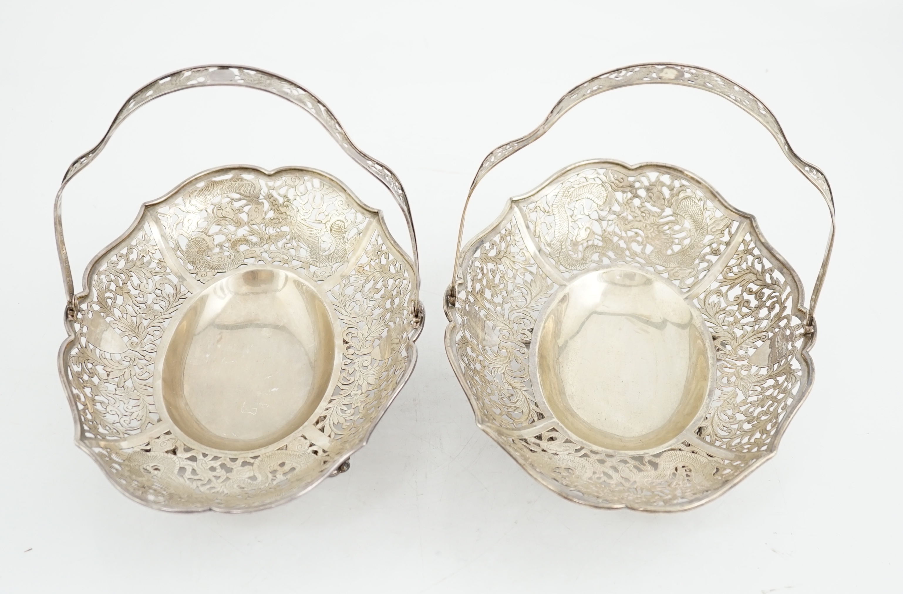 A pair of early 20th century Chinese Export pierced silver cake baskets, by Wang Hing, Hong Kong